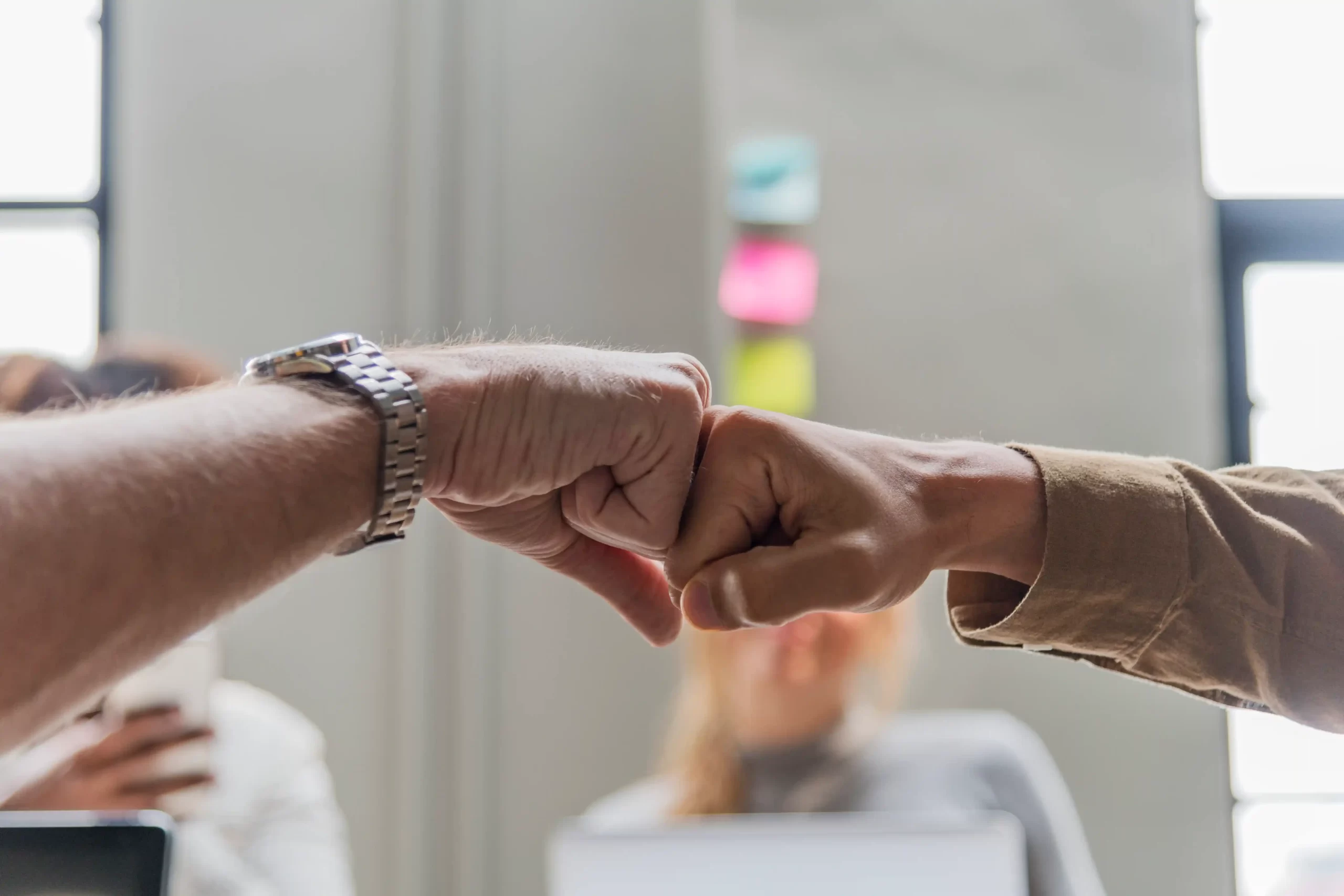 two people giving fist bump